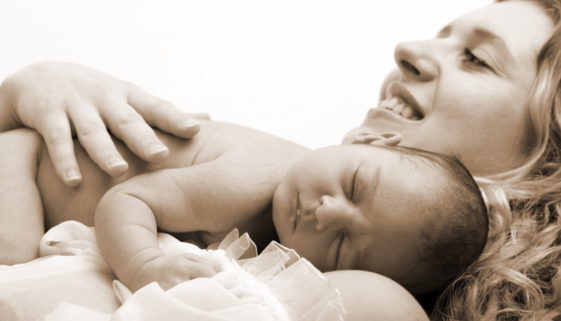 Newborn sleeping child in the hands of mother