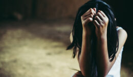 Little sad girl hiding or locked in the basement. trafficked and
