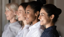 Side view row of diverse female staff of company