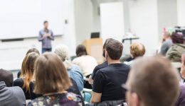 Man giving presentation in lecture hall at university.