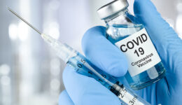 Healthcare cure concept with a hand in blue medical gloves holdi
