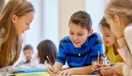 group of students talking and writing at school
