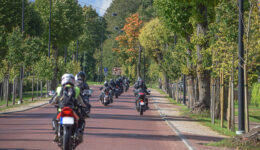 Motorcyclists riding down an alley