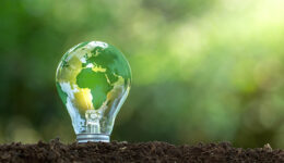 O mapa do mundo verde está em uma lâmpada que representa energia verde, energia renovável.