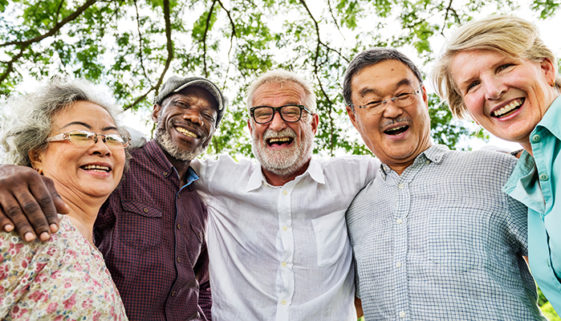 Grupo de cinco idosos sorrindo para a foto.