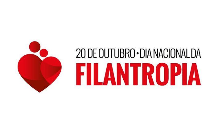 Imagem de fundo branco. Na linha central, à esquerda, está desenhado um coração vermelho; ao lado direito do coração está escrito, em preto, '20 de outubro, Dia Nacional da...' '...Filantropia', em vermelho.