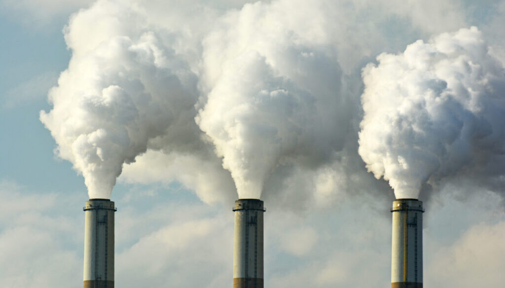 Multiple Coal Fossil Fuel Power Plant Smokestacks Emit Carbon Di