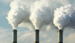 Multiple Coal Fossil Fuel Power Plant Smokestacks Emit Carbon Di