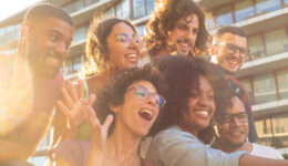 Joyful multiethnic friends taking funny group selfie