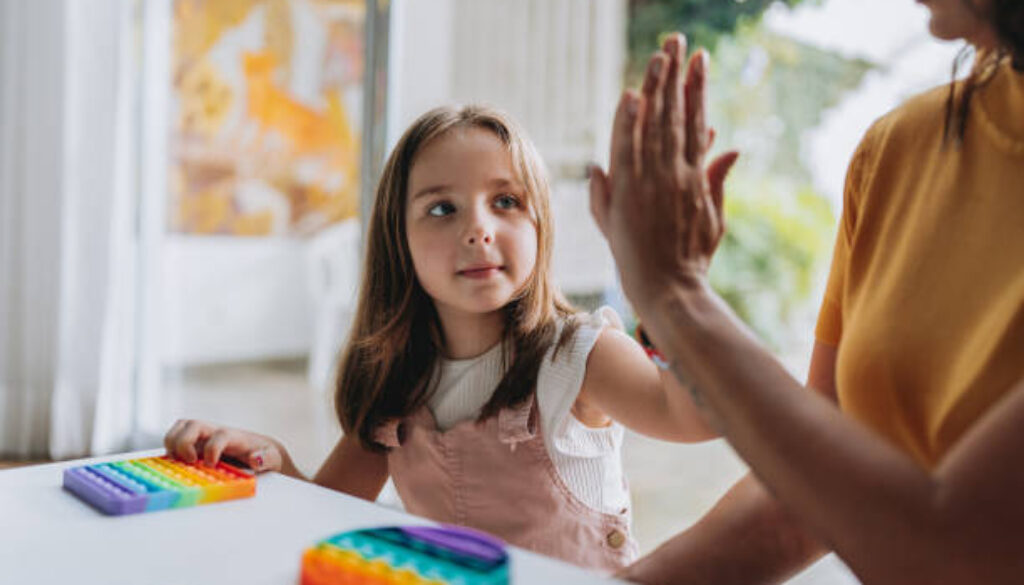 mother playing with autistic daughter