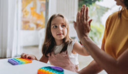 mother playing with autistic daughter